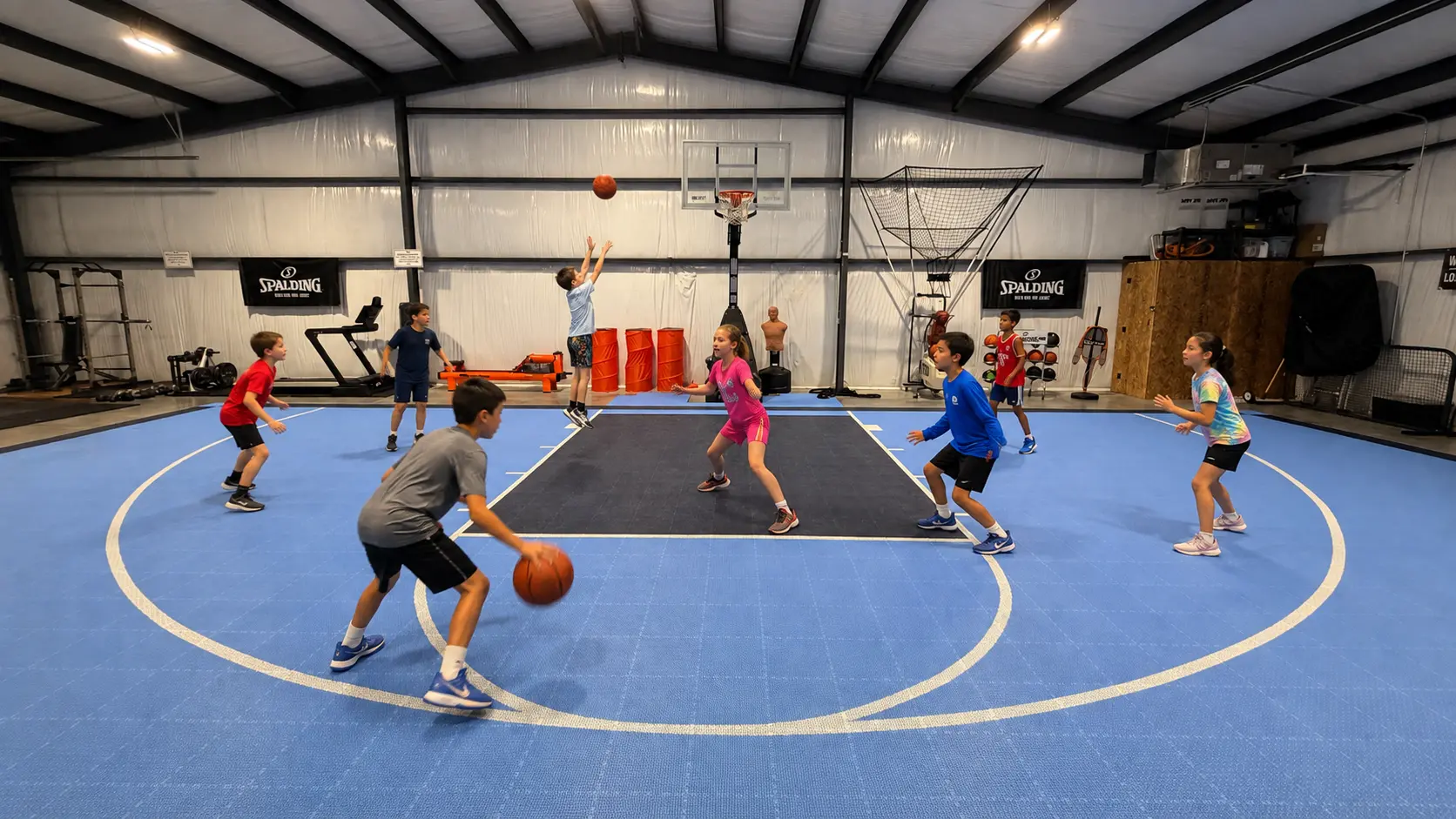 Kids playing basketball on the indoor court at Elite Labs